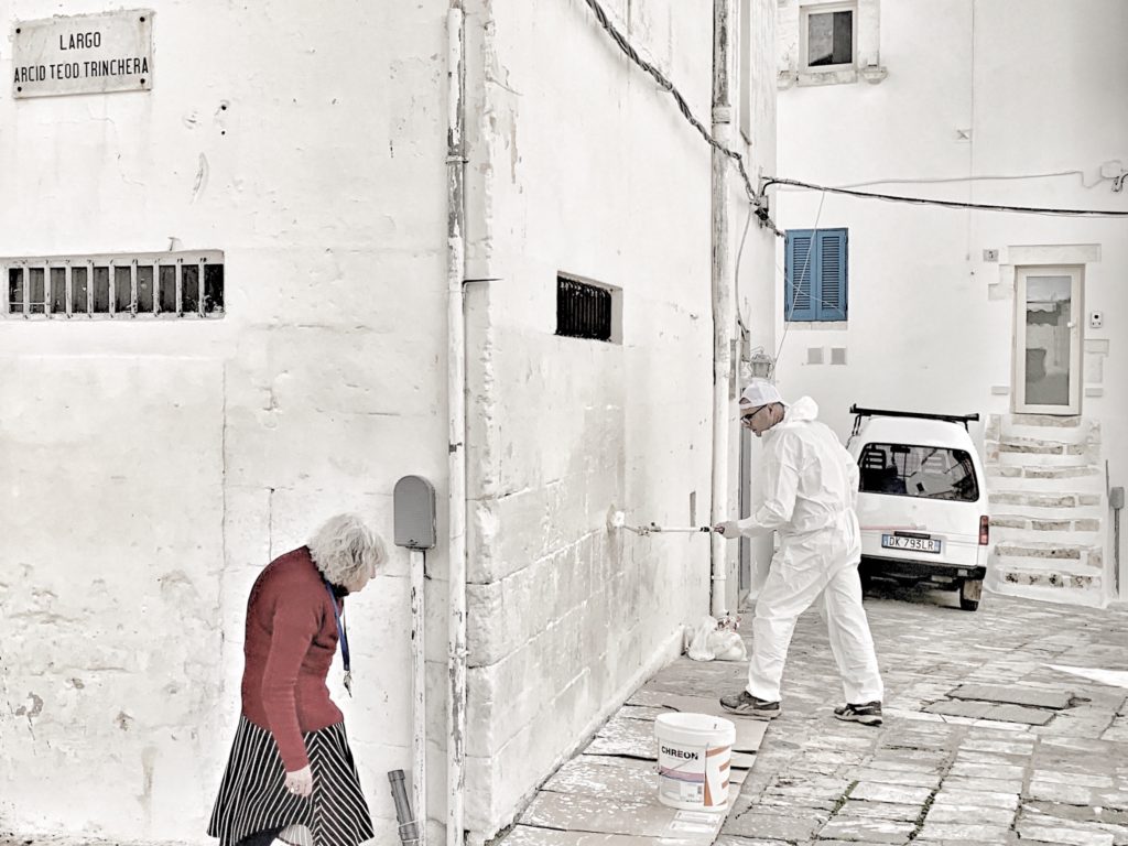 whitewashing Ostuni walls, Ostuni Puglia