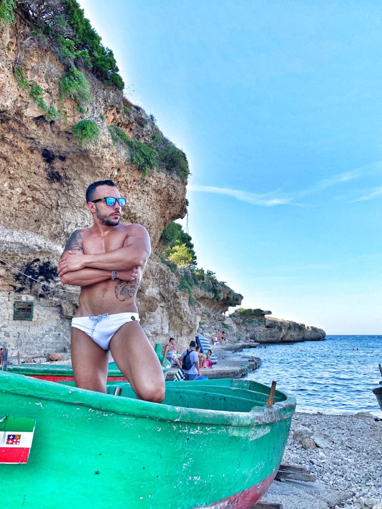 Torre Incina beach, situated between Polignano a Mare and Monopoli is a narrow rocky cove. The beach is popular with nudists and has a gay nudist beach | Photo © the Puglia Guys for the Big Gay Podcast from Puglia guides to gay Puglia, Italy’s top gay summer destination