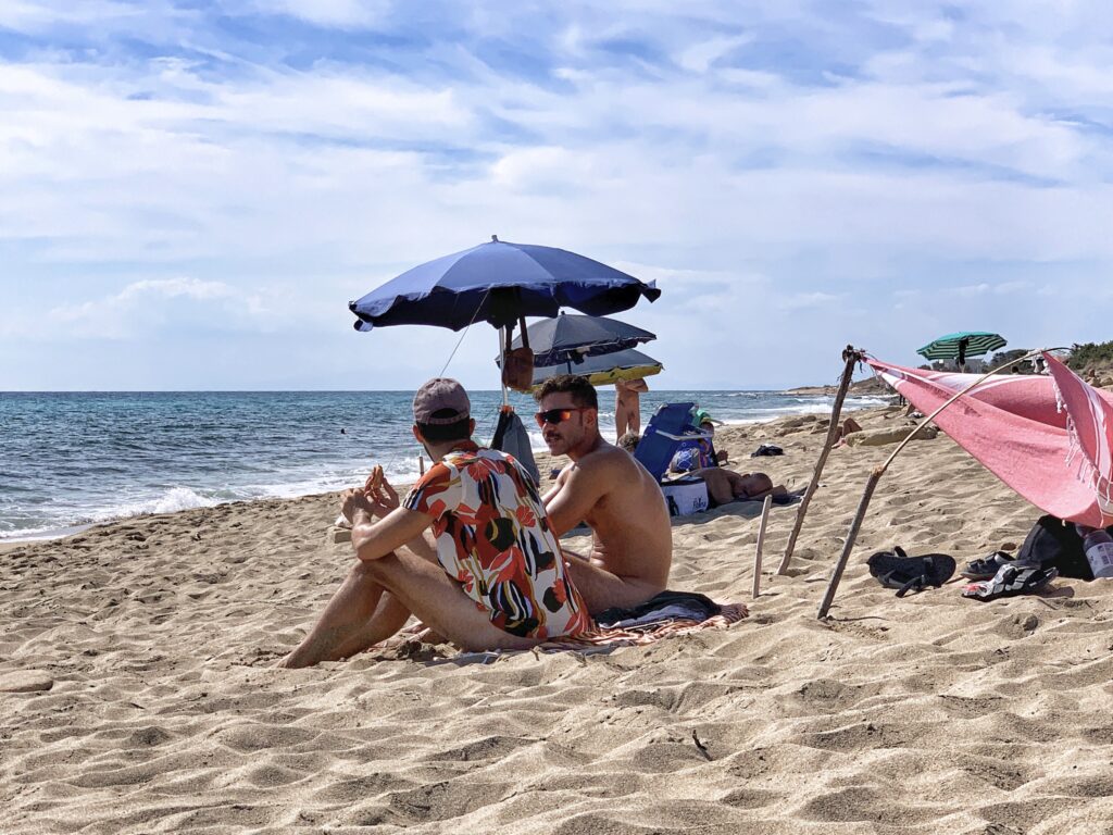Visitors from Milan relax and enjoy Spiaggia D’Ayala, our favourite gay and naturist beach in Puglia, though it wasn’t the top choice in out Best of Gay Puglia Survey 2020.