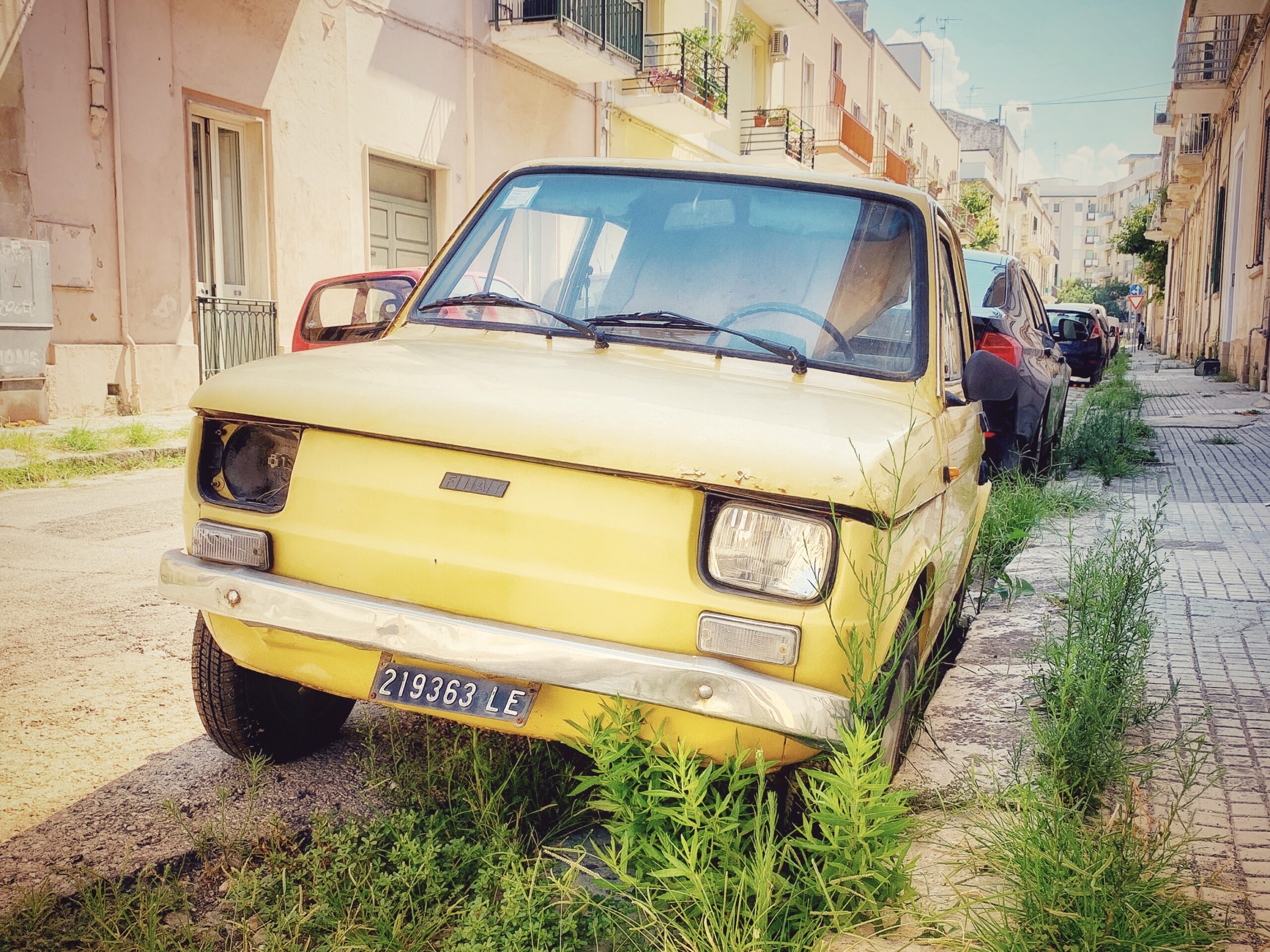 A car in Lecce, Puglia that has seen better times. Our guide to driving in Puglia.