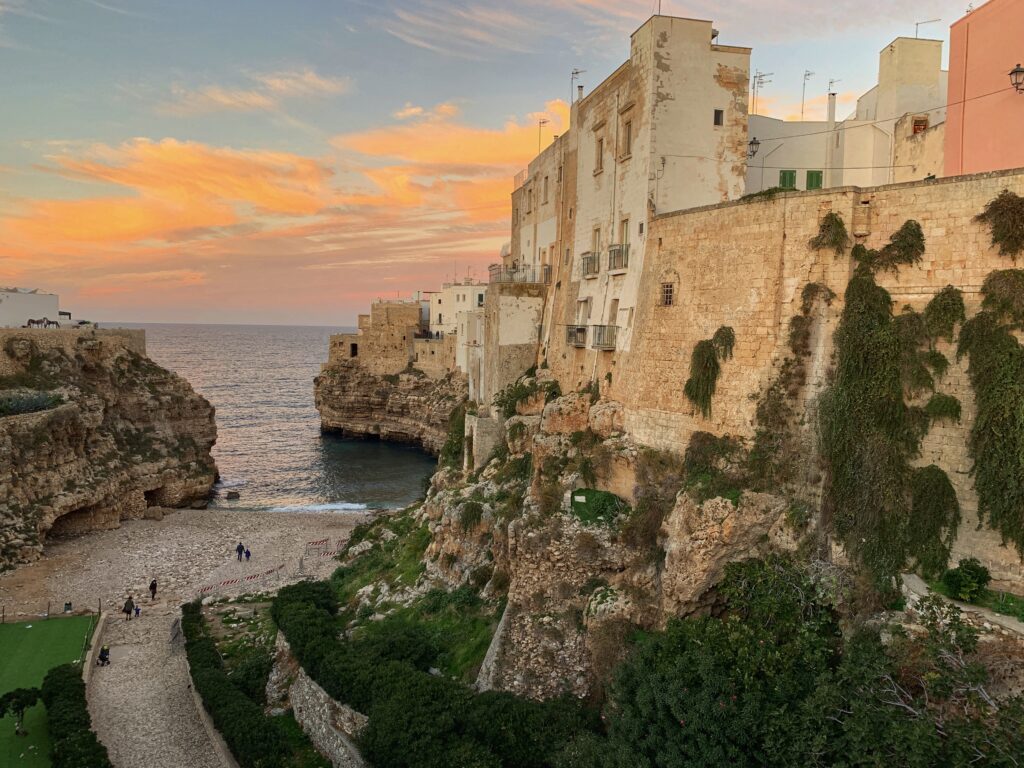 Polignano a Mare has one of Puglia’s most iconic views. Puglia is Italy’s top gay summer destination for LGBT travel with a variety of gay and nudist beaches, gay bars and clubs and a chilled gay scene. Photo by the Puglia Guys for The Big Gay Podcast from Puglia.