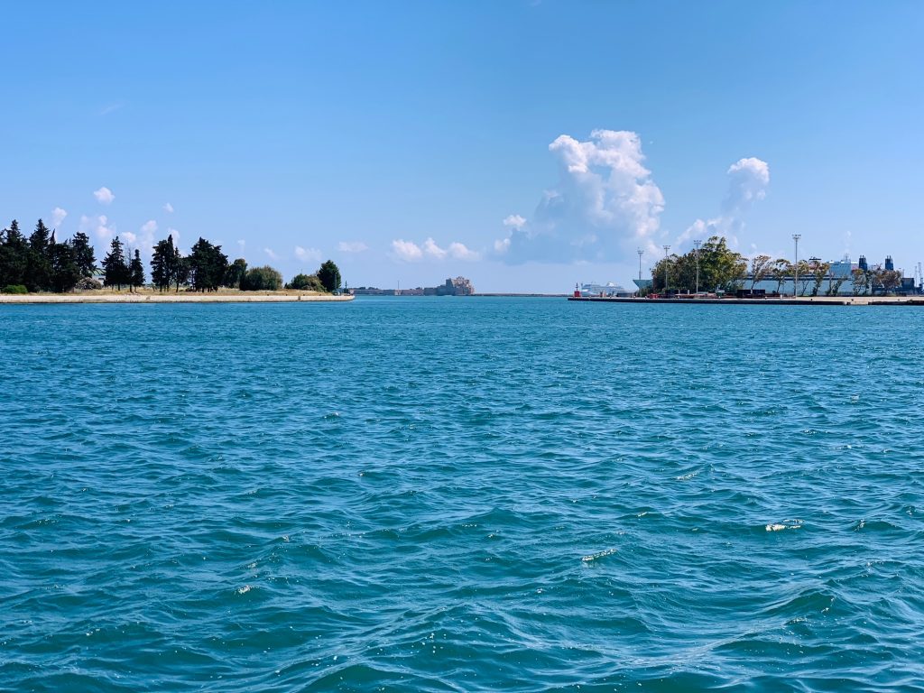 Looking out over the entrance to Brindisi port, over the Castello Alfonsino di Brindisi | Photo © the Pugli Guys for the Big Gay Podcast from Puglia, Italy’s top gay summer destination