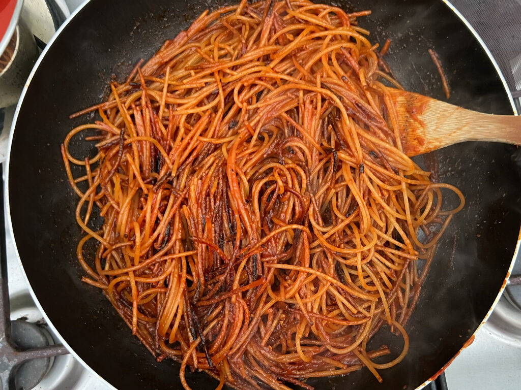 Spaghetti all’assassina from Bari, Puglia. A spaghetti dish unlike any other, cooked using the risottatura method. The spaghetti is cooked raw, to ensure it is burnt and crispy. Photo and cooking by the Puglia Guys.