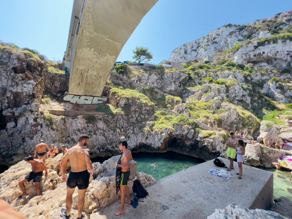 Il Ciolo, Gagliano del Capo - one of Puglia’s most beautiful swimming spots, in a dramatic canyon underneath a bridge | Photo © the Puglia Guys for the Big Gay Podcast from Puglia guides to gay Puglia, Italy’s top gay summer destination