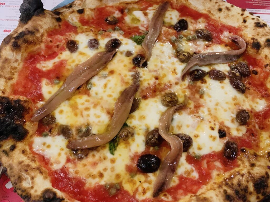 Pizza from Luppolo & Farina pizzeria in Latiano, Puglia, one of Italy’s top 50 pizzerias according to Italian food journalist Luciano Pignataro | photo the Puglia Guys for the Big Gay Podcast from Puglia travel guides to Italy’s top gay summer destination for LGBTQ travel.