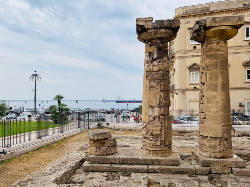 Numerous artifacts and monuments that tell the story of Taranto’s Greek past remain, including a row of Greek columns standing near the water. Photo copyright the Puglia Guys for the Big Gay Puglia Guide. Travel and city guides to Italy’s Puglia region.