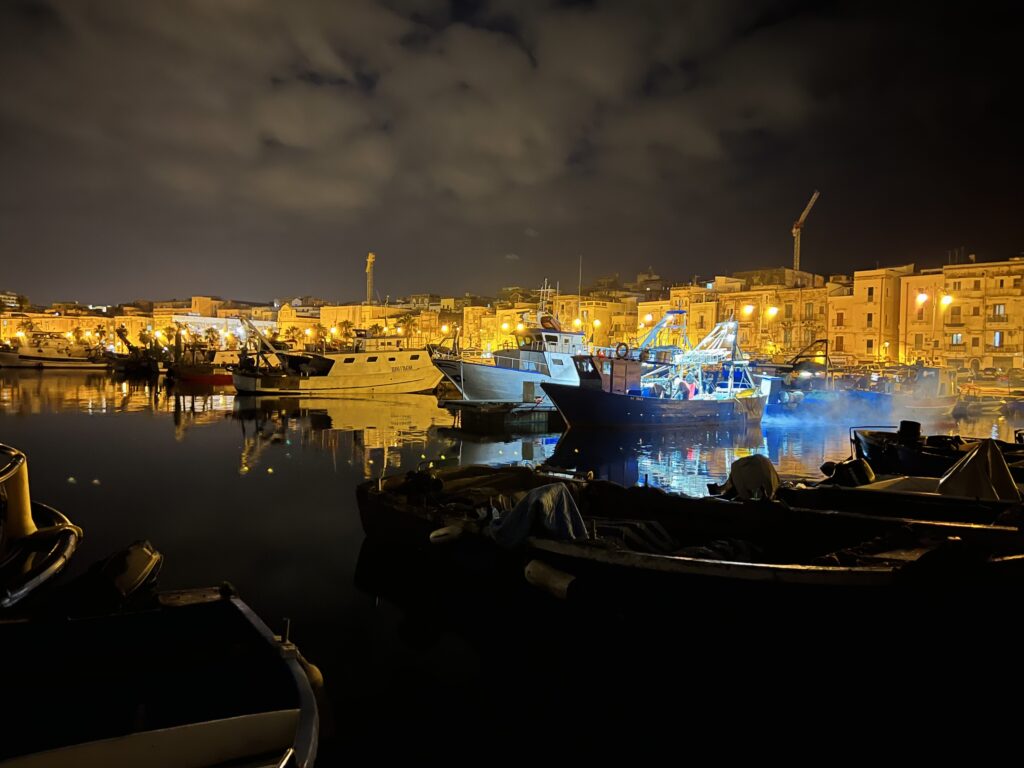 Taranto’s old port at night. Taranto’s old town is raw and gritty. As is obvious from the very dilapidated state of many of the buildings, this is an economically challenged part of Taranto. A slow gentrification of sorts is coming. The port is a busy working one, where fishing boats jostle for space. Photo copyright the Puglia Guys for the Big Gay Puglia Guide. Travel and city guides to the Puglia region of Italy.
