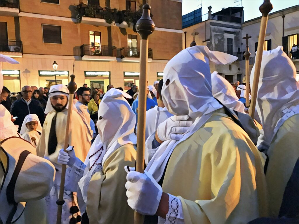The Pappamusci from Francavilla Fontana are also a traditional part of Easter Holy Week celebrations in Puglia. Francavilla Fontana’s Holy Week traditions are known for their unique and elaborate costumes.  This is the most sacred time of the year. A time when the religious traditions and cultural heritage of our region come to the fore. For visitors it is a unique time to experience the authentic customs and rites that have been passed down through generations. Photo copyright ©️ the Puglia Guys for the Big Gay Puglia Guide